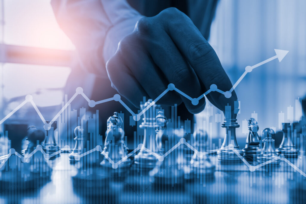 Hand moving chess piece on board, overlaid with growth chart. Innovation strategy.