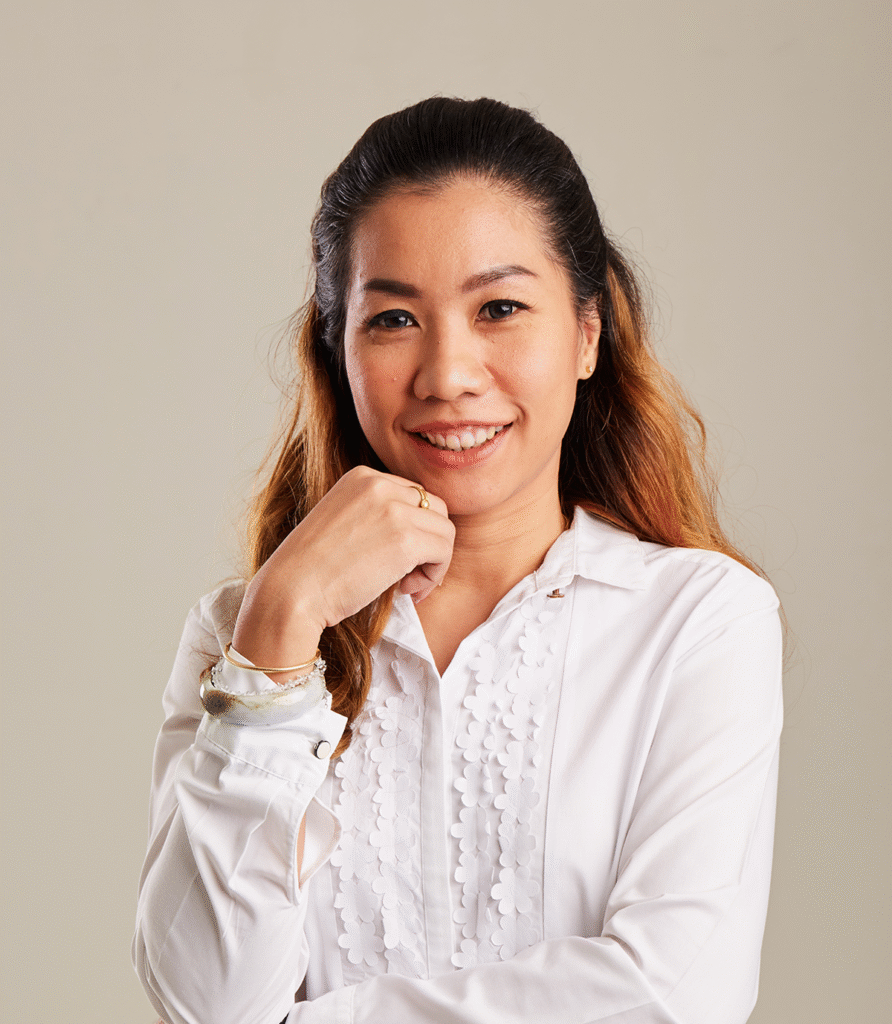 Smiling Asian woman in white ruffled blouse
