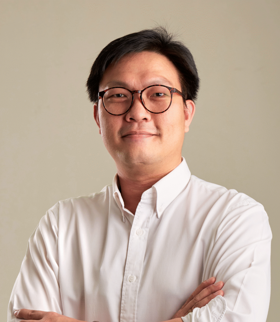 Portrait of a man wearing glasses and a white shirt